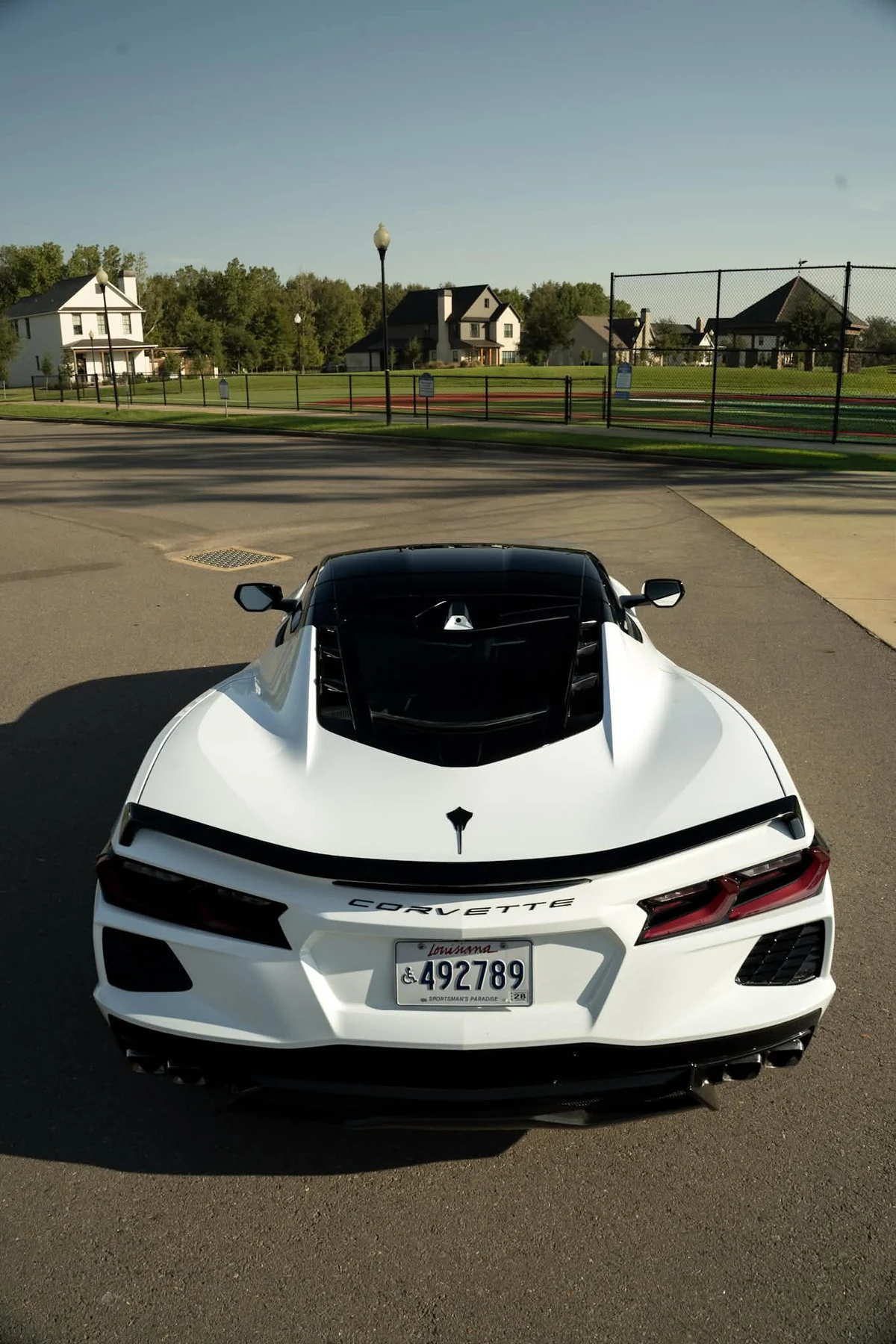 White Chevrolet Corvette C8 with black wrapped roof and pillar accents